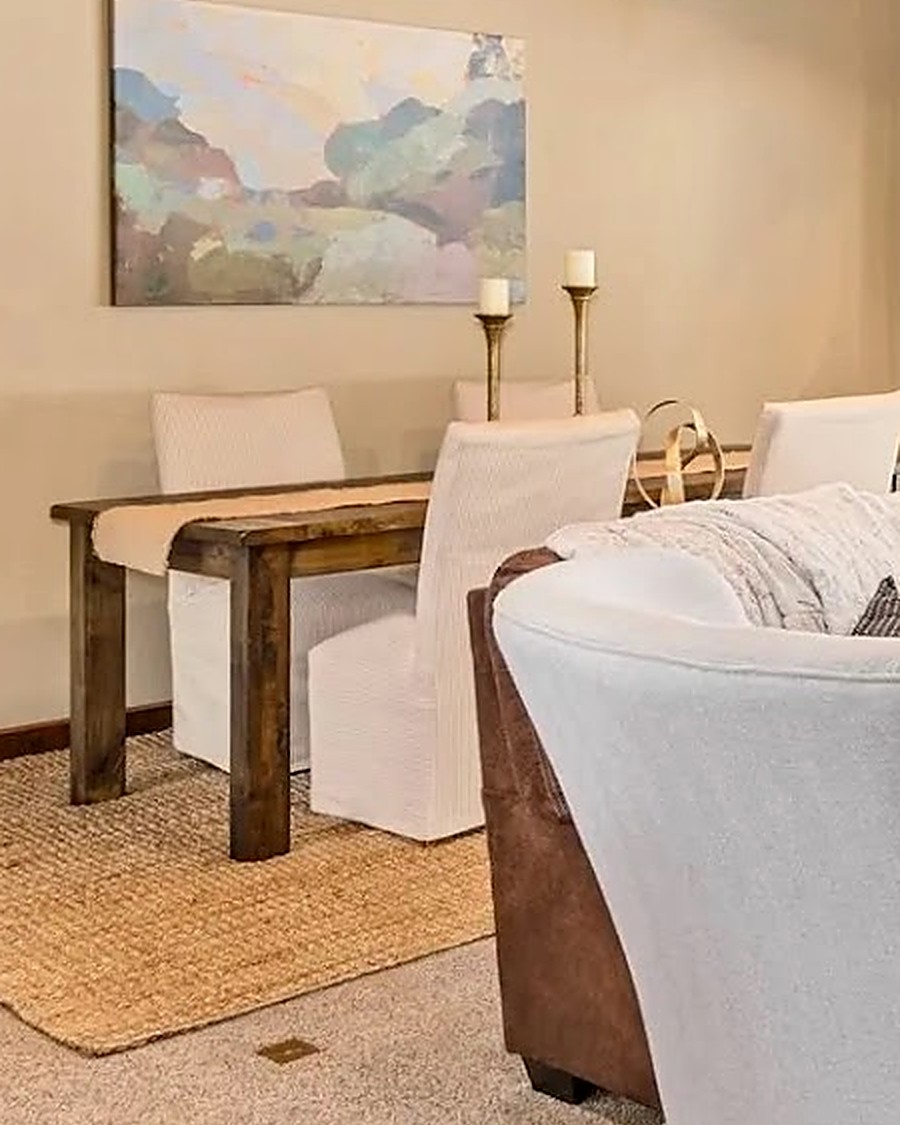 Styled console table with abstract landscape art and brass candlesticks