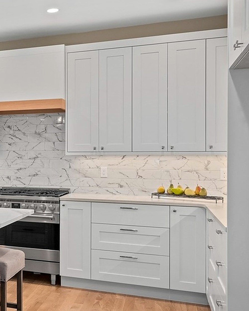 Detail of a marble slab backsplash behind a professional range