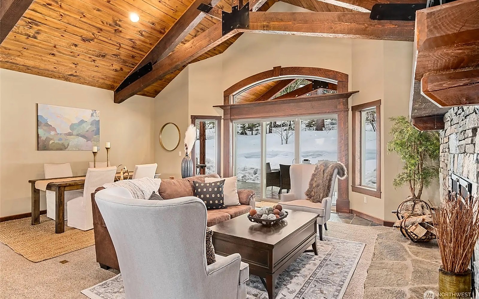 Untethered Interior Design hero photo — a vaulted mountain lodge great room with a stone fireplace and timber beams